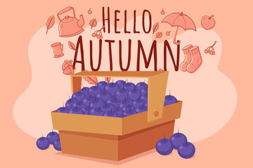 Wooden basket filled with fresh blueberries against warm autumn-themed background. Festive elements like leaves and seasonal items inviting change of season