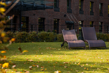 Banner. Two sun loungers on a green lawn in the hotel courtyard. The concept of rest, relaxation,...