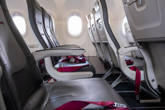 Airplane cabin interior with empty seats and window light, illustrating modern air travel comfort and minimalist design for business and transportation themes