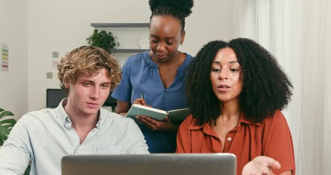 Diverse Startup Team Collaborating on a New Tech Project in a Modern Office
