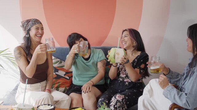 Women chat and share drinks in an inclusive bar