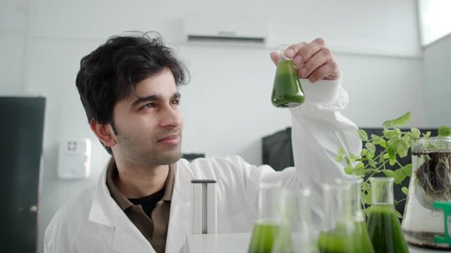 Scientist examines algae sample in modern plant physiology lab
