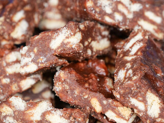 Close-up of blocks of chocolate brownie and biscuit sweets stacked on top of each other