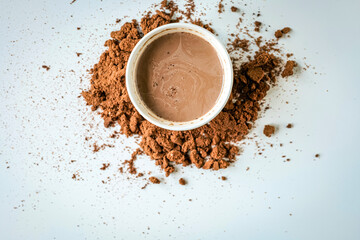 Top view of cocoa drink and cocoa powder on white background