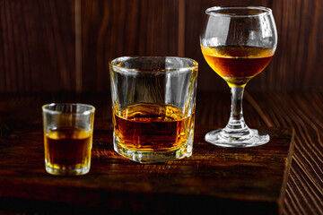 Strong alcohol drink. Whisky in glass, liqueur, bourbon or cognac. Hard strong alcoholic drink various glass forms