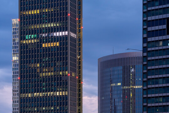 Twin glass skyscrapers in Frankfurt reflecting evening sky, illustrating modern architecture, finance and corporate identity within urban development