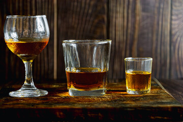 Strong alcohol drink. Whisky in glass, liqueur, bourbon or cognac. Hard strong alcoholic drink various glass forms
