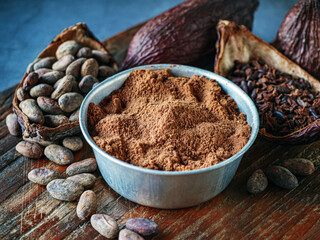 Close-up of Natural cocoa powder with brown cocoa beans and dry cacao nibs