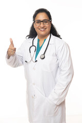 Fototapeta premium Indian Female doctor standing with her showing thumbs up and smiling. while isolated on white background.