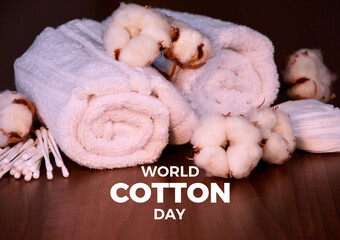 World Cotton Day poster stock photo images. Cotton plant, swabs and white towels on a wooden background. Template for background, banner, card. 7 October. Important day