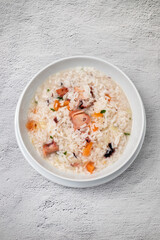 Boiled rice with octopus in white bowl