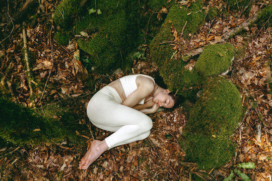 Person practicing relaxation and grounding in a forest setting