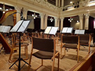 Music score with notes in hall of the conservatory at classical music concert