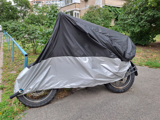 Black and gray cover on motorcycle parked in yard of house © Harmony Video Pro
