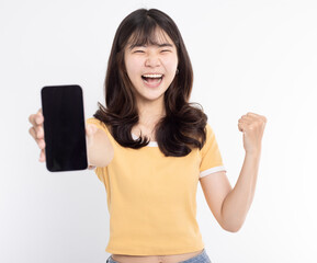 Asian girl showing or presenting mobile phone application and success gesture isolated over white background