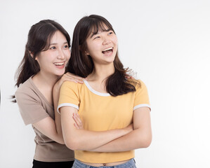 Portrait of two cheerful young women standing together
