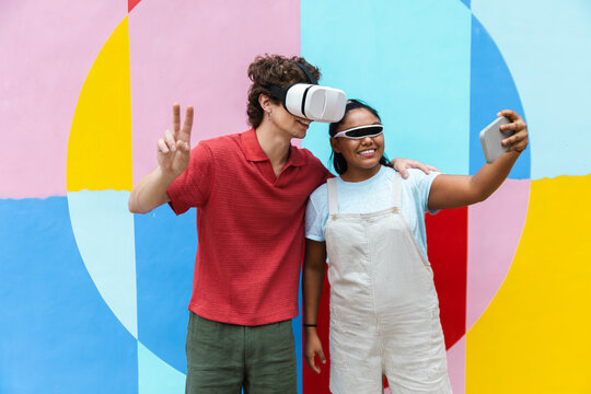 Friends taking selfie with virtual reality headset and prosthetic leg