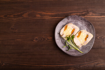 Chicken, egg and dried apricot meatloaf, microgreen on brown wooden. Diet, healthy eating. top view, copy space