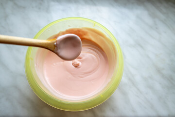 Bowl of pudding mixture with wooden spoon