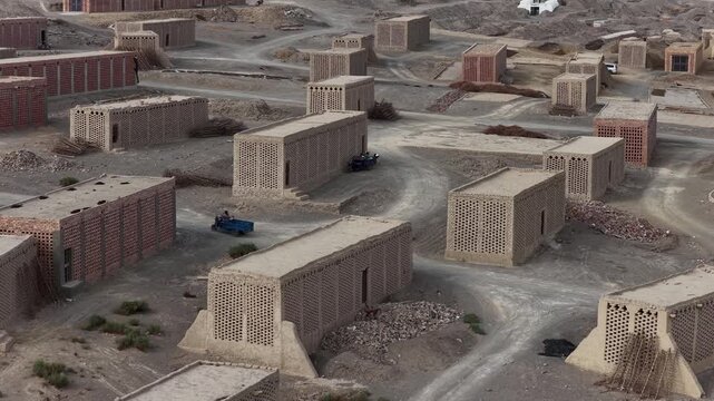 Aerial view of the mud bricks storehouses in Turpan, with a stark contrast between the arid landscape and the geometric structures, Turpan, China.