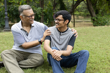 Fototapeta premium Father Love Son. Old Indian father with his young son spending time at park. Concept : Happy Fathers Day. 