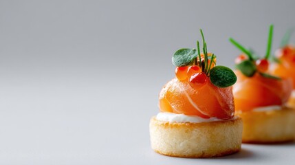 Delicious salmon appetizers arranged beautifully on a light background. The appetizing salmon sits atop a creamy base on small, perfectly browned bases