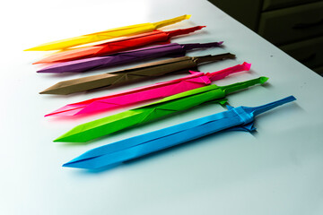 Fototapeta premium Paper sword. Origami knife. Paper weapons. Crafts.