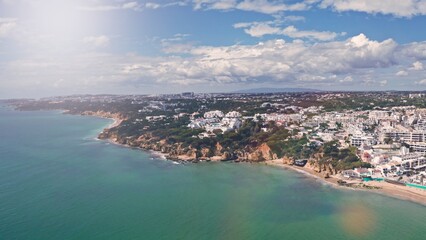 Fototapeta premium Aerial drone shot of Algarve Portugal coastline cliffs golden sandy beaches turquoise Atlantic Ocean resort hotels buildings scenic seascape travel destination summer holiday paradise trip traveling