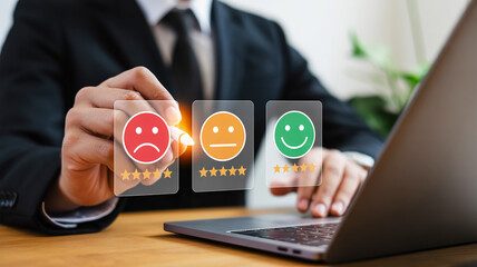 Person selecting happy face emoji and stars for customer feedback on digital screen satisfaction rating