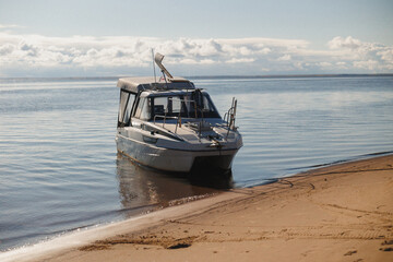 A tranquil boat rests peacefully on a stunning beachfront, surrounded by calm waters and a...