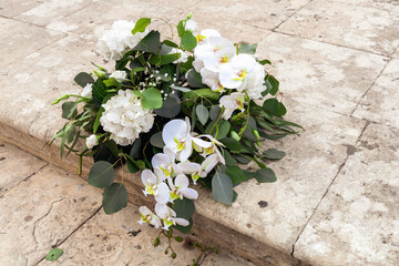 Beautiful bridal bouquet lying on stone staircase. High quality photo