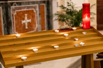 Flickering candle flame inside serene church interior. High quality photo