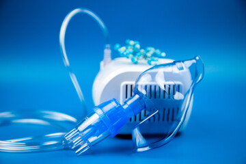 Close-up side view of a blue mask and a camera on a blue background. The concept of treating...
