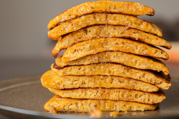 stack of pumpkin spice pancakes with a slice showing the fluffy texture