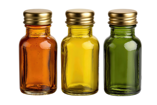 Elegant set of three hand-blown glass bottles, tinted amber, mustard, and green, with brushed brass lids, isolated on transparent background.