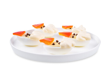Boiled eggs with pepper and mayonnaise sauce in the form of Santa Claus for Christmas holidays on a white isolated background