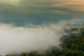 Amazing landscape fog mountain clouds scenery. Beautiful Mountain landscape foggy windy mountain range green landscape asian farm. Landscape mountain green field meadow white cloud blue sky sunrise