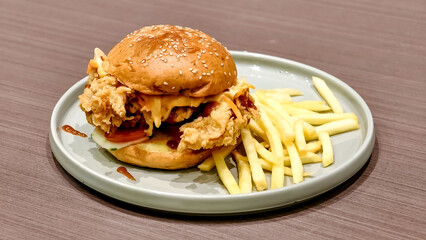 Delicious Fried Chicken Burger with Fries on a Plate - A Culinary Delight for Food Lovers