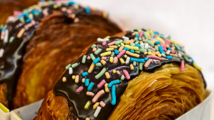 Sweet morning indulgence Flaky croissants generously dipped in dark chocolate and showered with...
