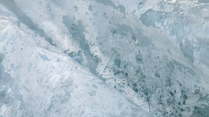 An abstract view of dewy plastic, revealing intricate patterns.