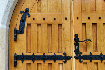 close up view of old wooden door made of planks and metal decorative elements as background