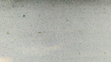 Close-up shot of a textured, weathered surface with subtle color variations and imperfections.