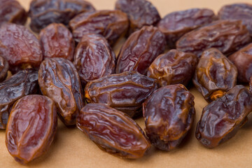 Dried dates on a brown background. Close-up of dried dates. Selective focus.