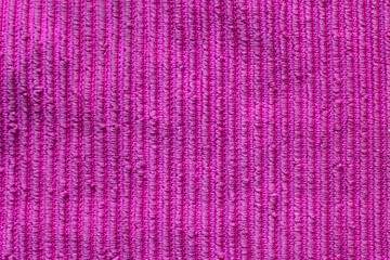 Vibrant fabric texture showcases deep magenta hues with rich ribbed patterns and soft fibers perfect for various fabric projects