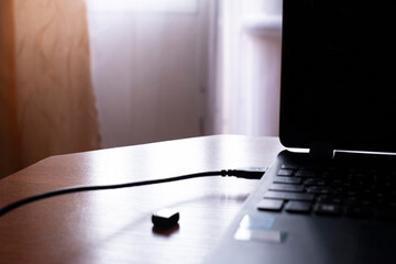Quiet moments of creativity at a dimly lit workspace with a laptop on a wooden desk