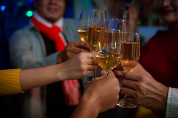 Happy friends celebrating Christmas at home Friends gather at home for a traditional Christmas dinner, young couples enjoying the festive food.