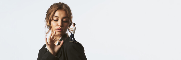 Collage of confident woman looking at tiny man standing on her shoulder in dialogue pose. Concept...