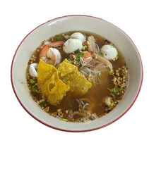 A bowl of delicious noodles with various toppings. It includes shrimp, squid, dumplings, and fish balls