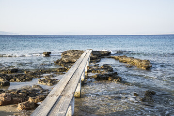 Fototapeta premium a wooden path leading into the Mediterranean Sea