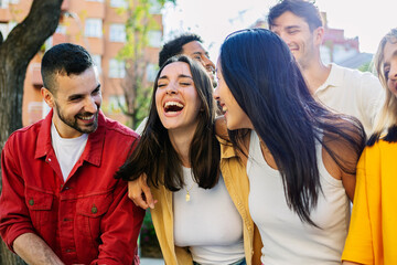 Diverse group of young friends having fun together outdoors during summer vacation. Youth and friendship concept
